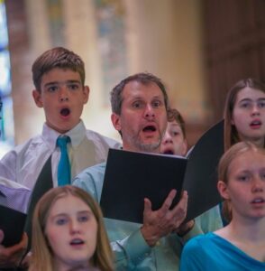 teenagers and one adult singing